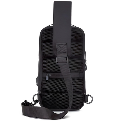 Back of a black minimalistic anti-theft crossbody bag with built-in lock and external USB charging port.