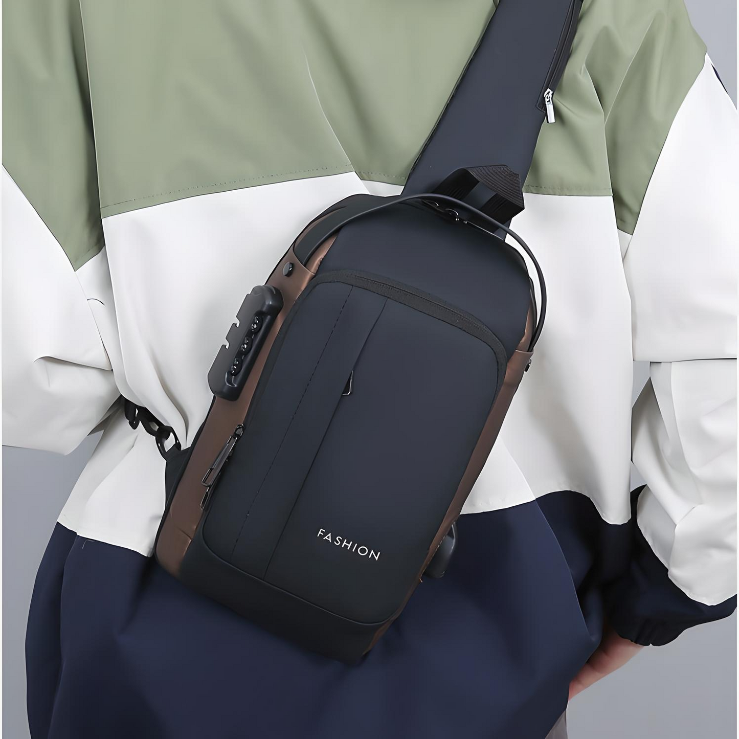 Person wearing a black and brown anti-theft crossbody bag with multiple pockets, a built-in lock, and an external USB port across their back.