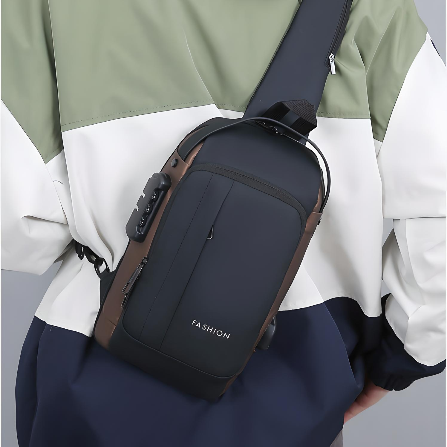 Person wearing a black and brown anti-theft crossbody bag with multiple pockets, a built-in lock, and an external USB port across their back.