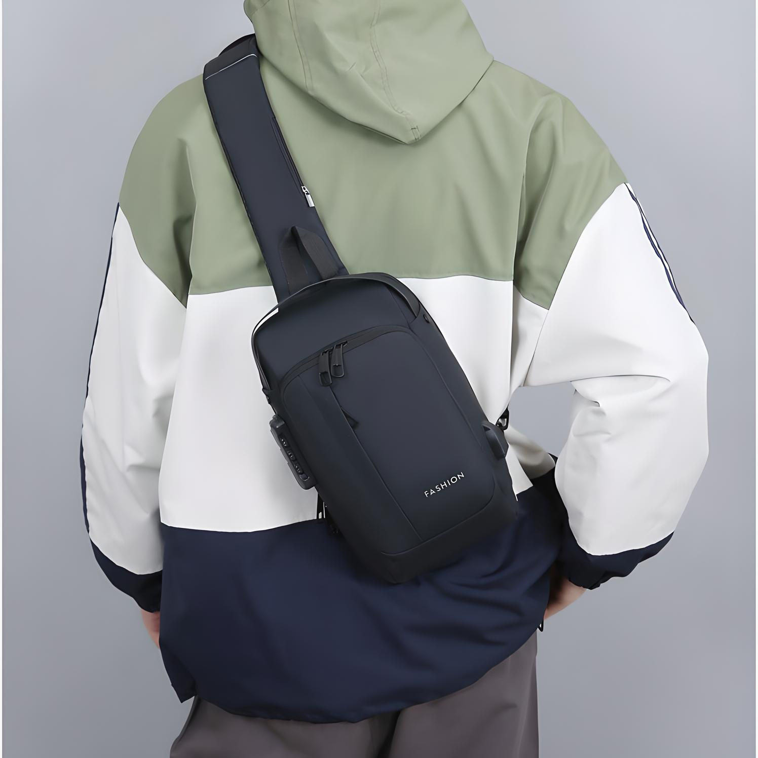 person weraing the black anti theft crossbody bag with multiple pockets, a built in lock and external usb port on their back