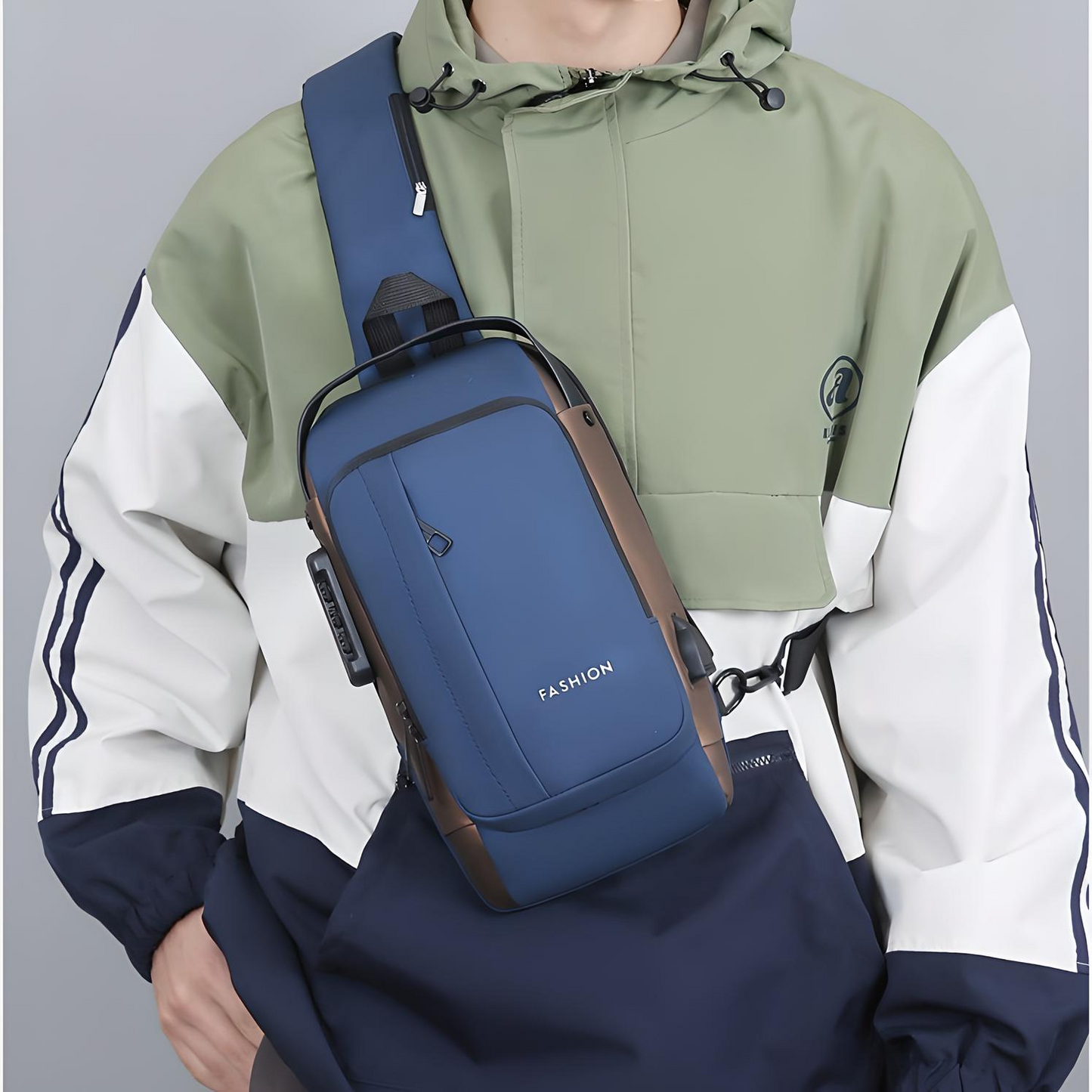 Person wearing a blue anti-theft crossbody bag with multiple pockets, a built-in lock, and an external USB port across their chest.