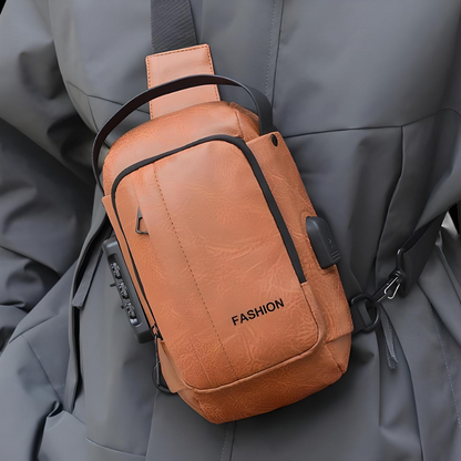 Person wearing brown mini crossbody bag with built in lock and usb port across their chest