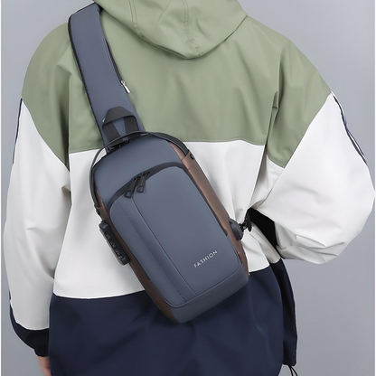 Person wearing a grey anti-theft crossbody bag with multiple pockets, a built-in lock, and an external USB port across their back.